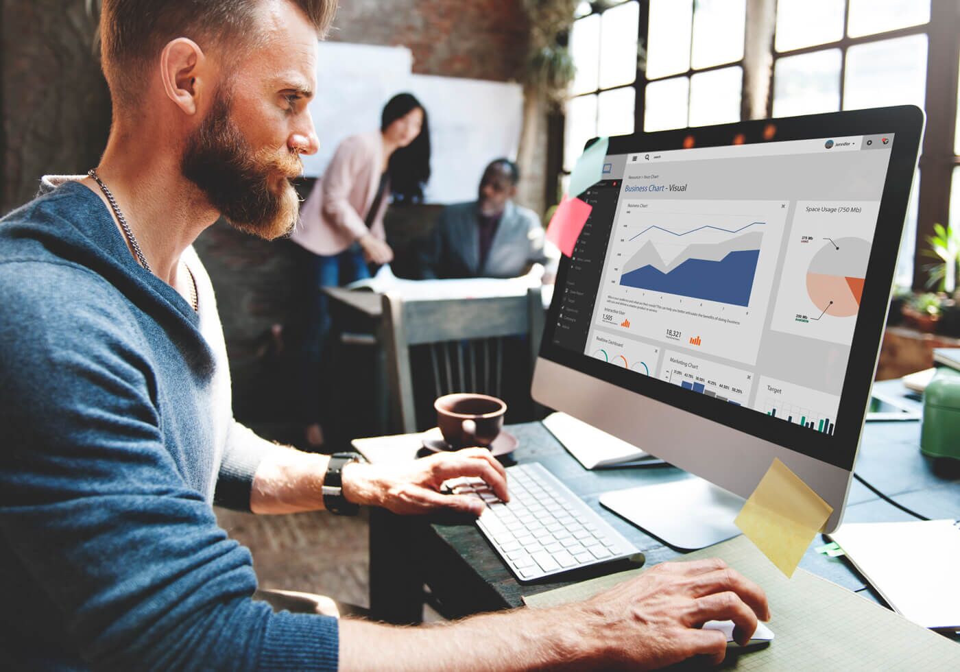 Man sitting in front of the computer researching What is Pay Per Click & Advertising on Stennett Designz? 3